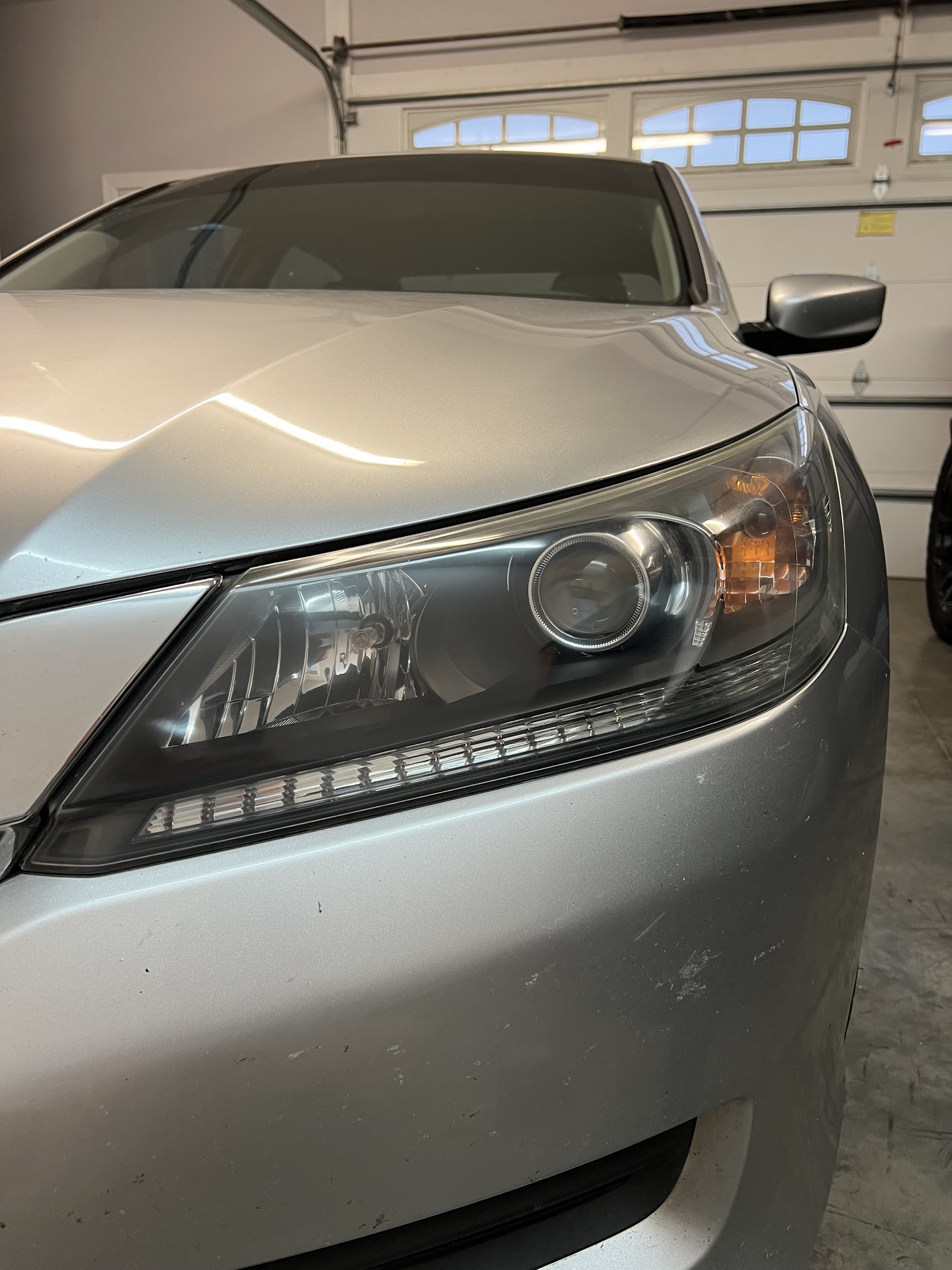 After restoration: clear lens on the same silver Honda